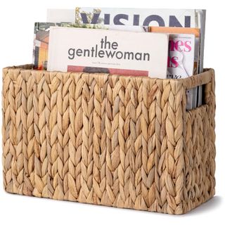 A wicker magazine basket filled with magazines