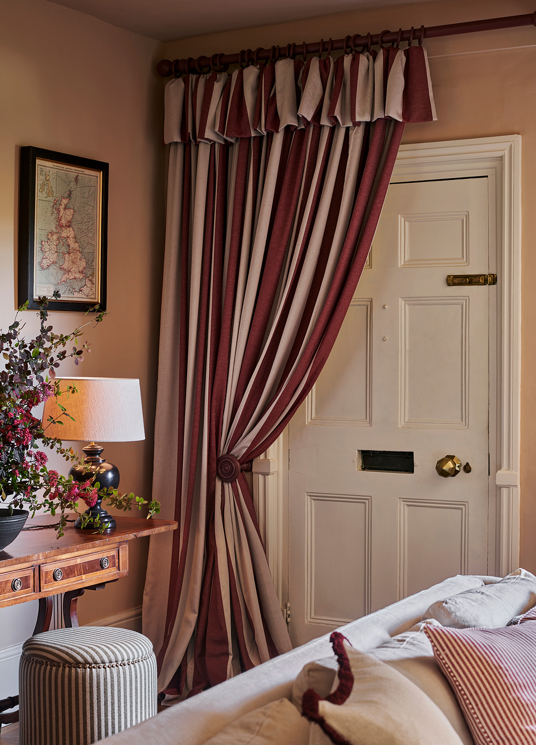 Pink living room with a front door covered with a pink fabric door curtain