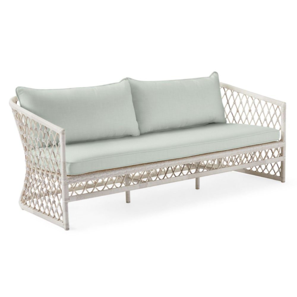 Wicker sofa with light green cushions