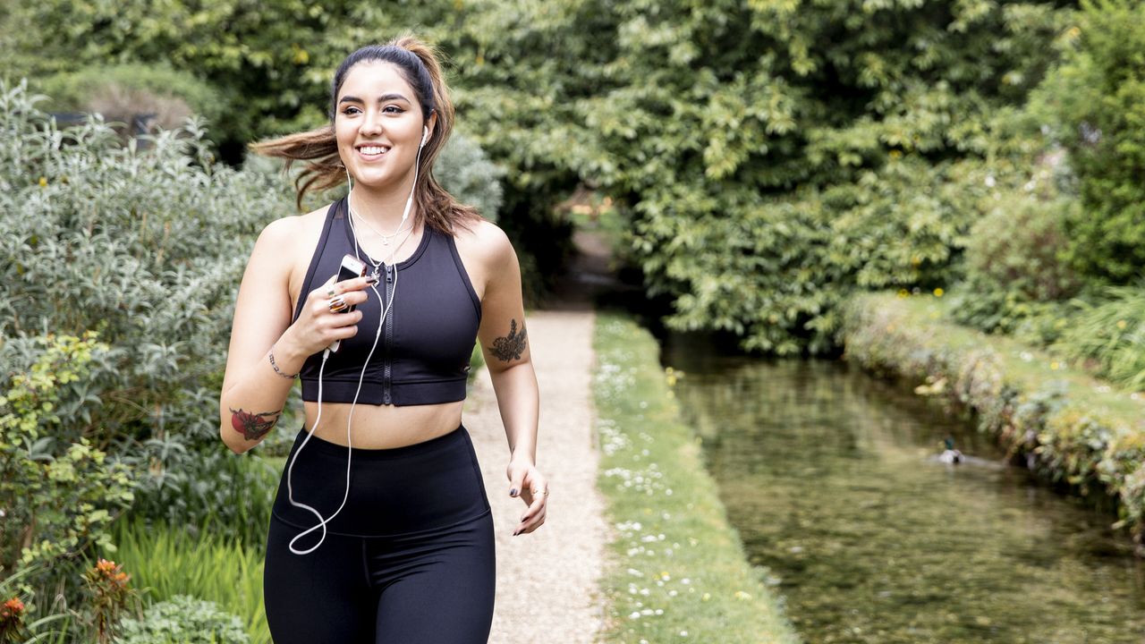 Woman running next to a waterway