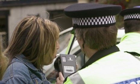 A policeman gives a breathalyzer test; Wisconsin has the highest rate of drunk driving -- 23.7 percent.