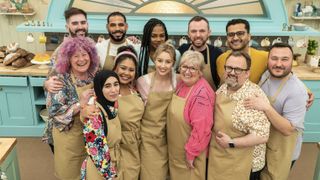 This series' bakers stand together in the tent wearing brown aprons in The Great British Bake Off.