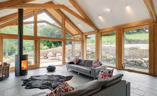 Living room with stove in timber-frame extension