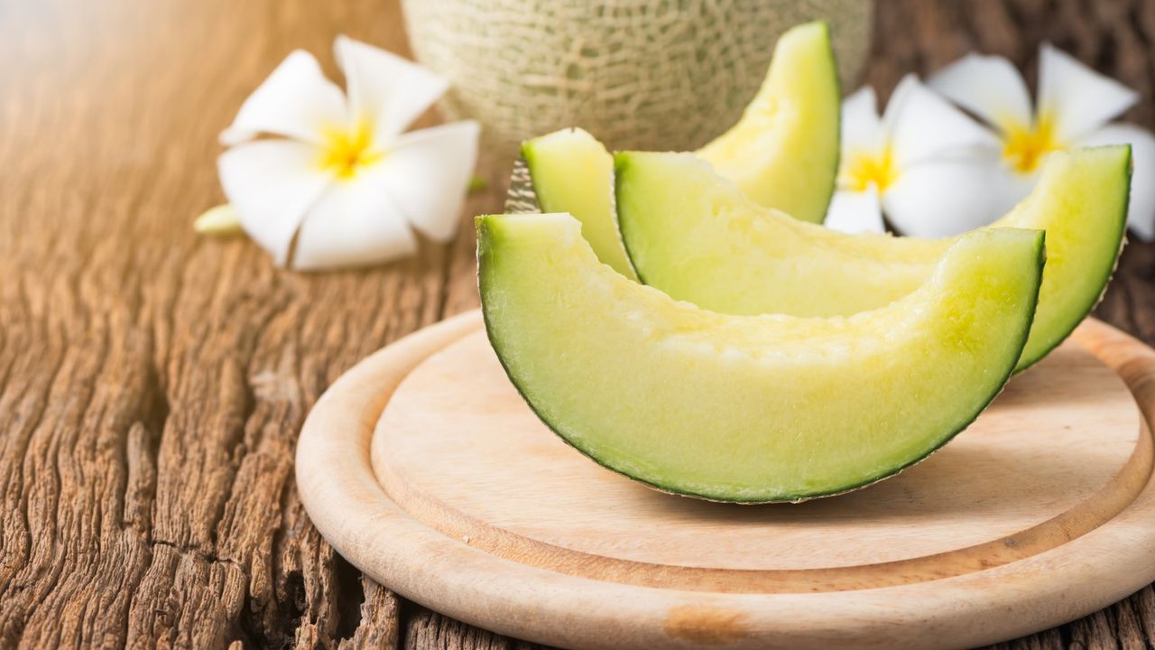 Sliced honeydew melon on a board