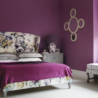 bedroom with purple wall and mirror