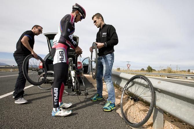 Jeremy Hunt and Andrej Hauptman help Ismail Iliasov with a puncture