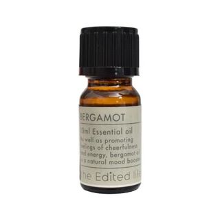 Brown bottle of Bergamot Essential Oil with a cream label and black lid