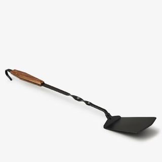 A stainless steel spatula with wooden handle