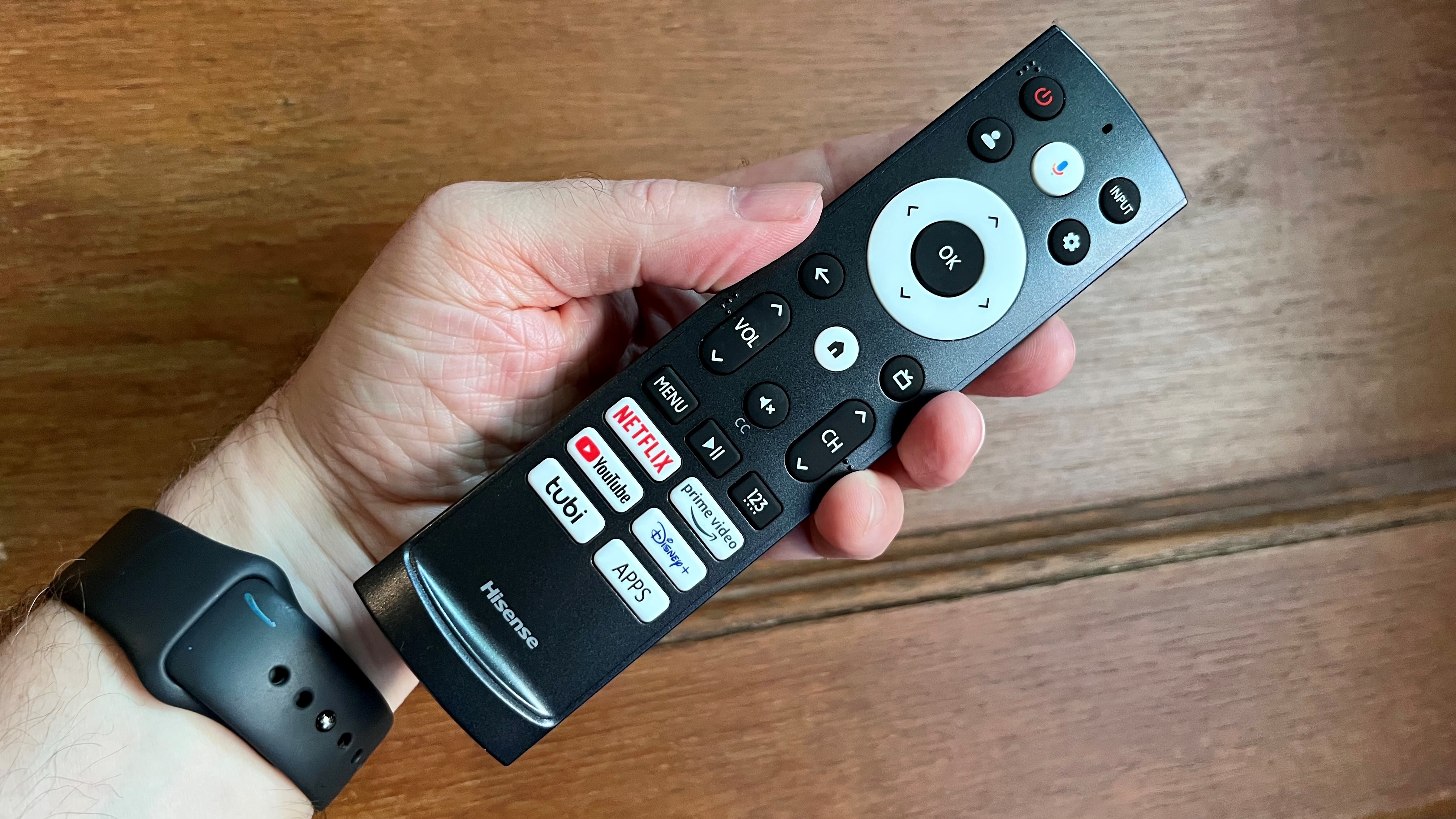 Hisense U8K remote control held in hand