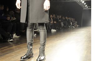 Model wearing black shoes, pants and coat