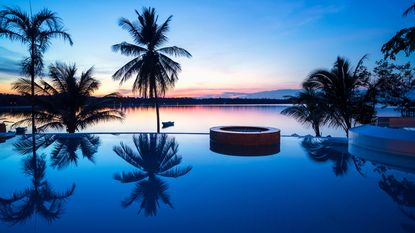 A photo of one of the most amazing swimming pools in the world at sunset