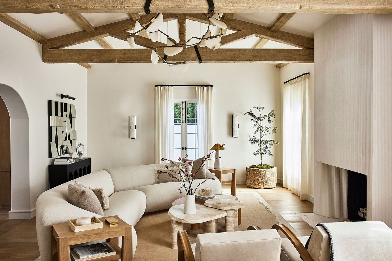 Open neutral lounge with cozy furnishings, curved couches and exposed wooden beams, exuding warm minimalism trend