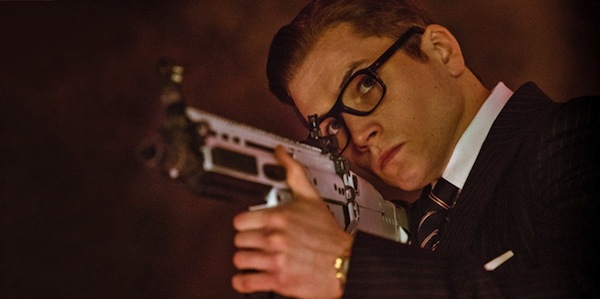 Kingsman The Secret Service Taron Egerton Eggsy aims a gun