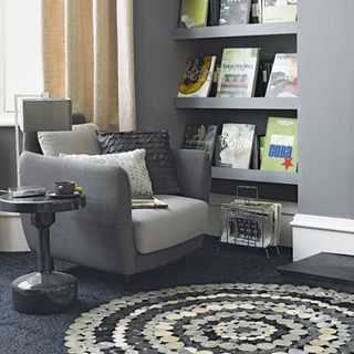 library area with grey wall and patchwork rug