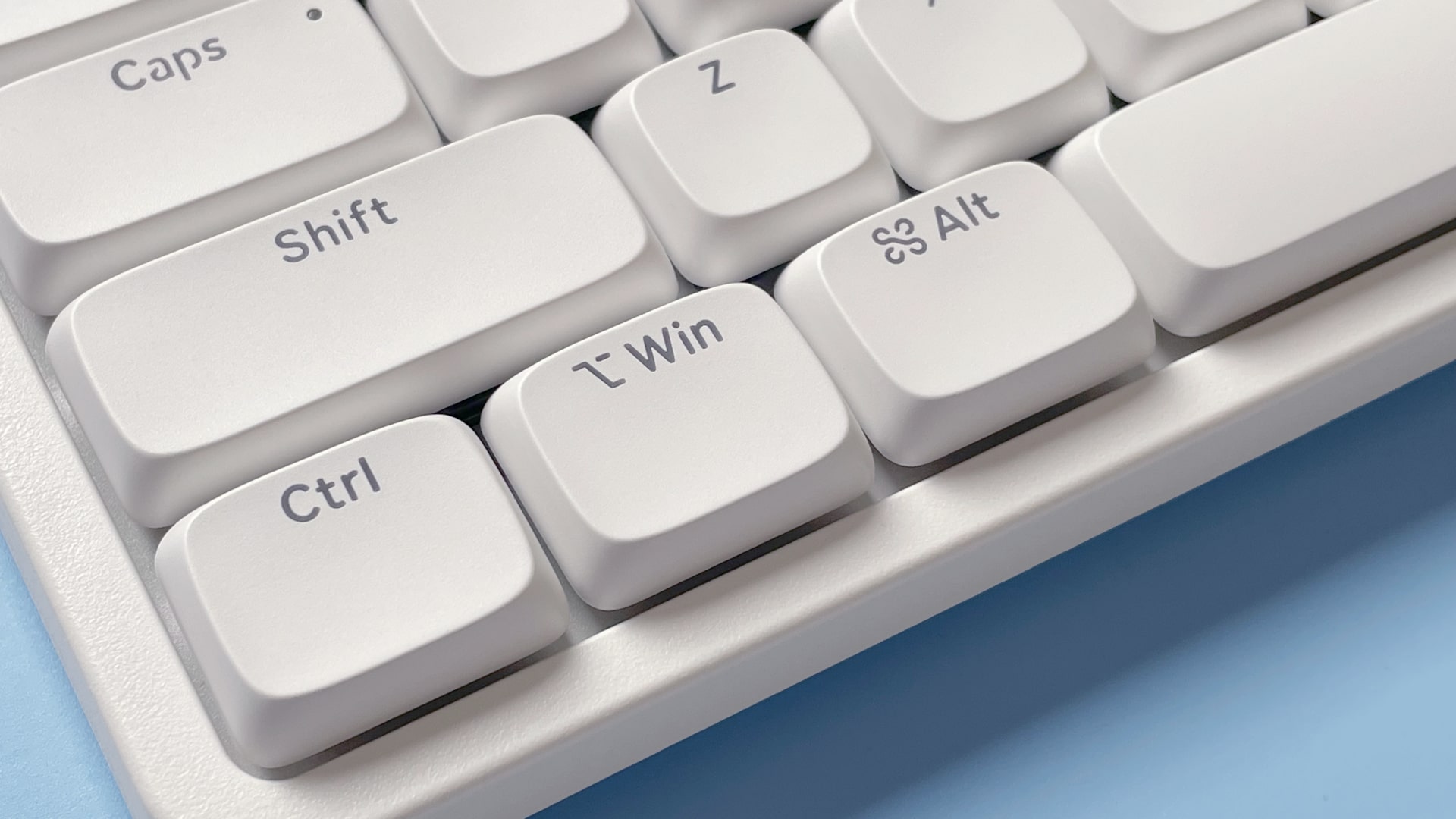 The Lofree Flow Lite mechanical keyboard against a blue background.