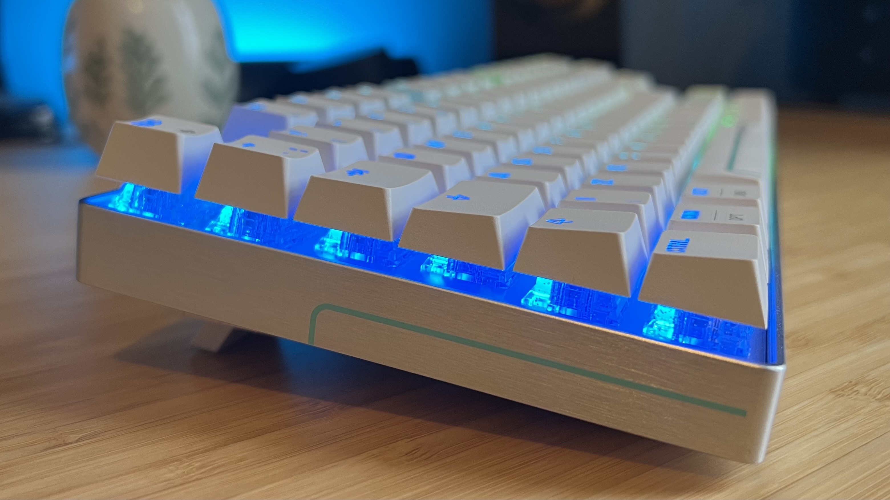 Side view of Cherry XTRFY MX 8.2 Pro TMR Wireless gaming keyboard on a wooden desk