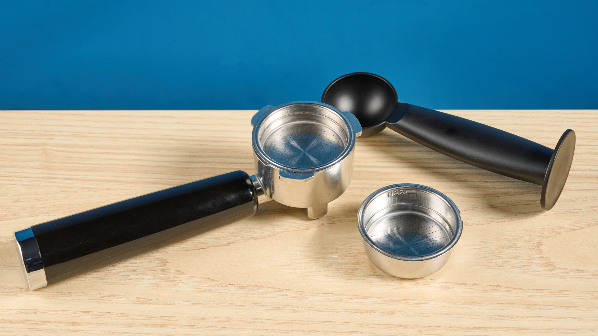 the casabrews 3700 essential espresso machine photographed against a blue background in stainless steel