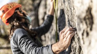 rock climbing techniques: climber gripping holds
