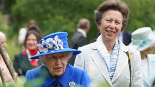 Britain's Queen Elizabeth II and Britain's Princess Anne, Princess Royal gesture during a visit to The Children's Wood Project in Glasgow on June 30, 2021, as part of her traditional trip to Scotland for Holyrood Week. (Photo by Andrew Milligan / POOL / AFP)