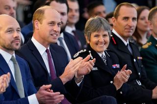 Britain's Prince William, Duke of Cambridge (2L) and Metropolitan Police Commissioner Cressida Dick (2R) applaud during The Royal Foundation's Emergency Services Mental Health Symposium in London