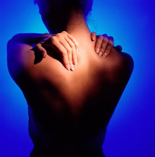 What causes pain between the shoulder blades