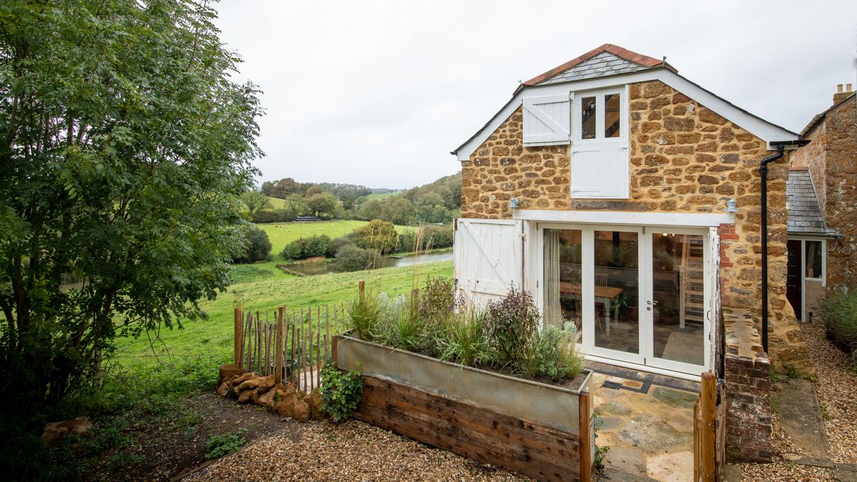 stone outbuilding garage with bifold doors