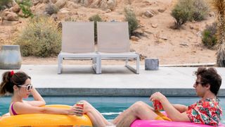 Cristin Milioti and Andy Samberg sit on floats in a pool in Palm Springs