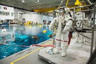 European Space Agency astronaut Samantha Cristoforetti wears a NASA spacesuit ahead of spacewalk training inside the Neutral Buoyancy Laboratory, a giant training pool near the Johnson Space Center in Houston.