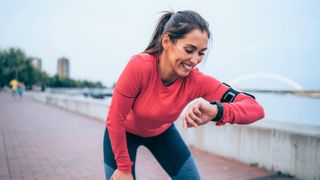 Woman checking GPS watch during run