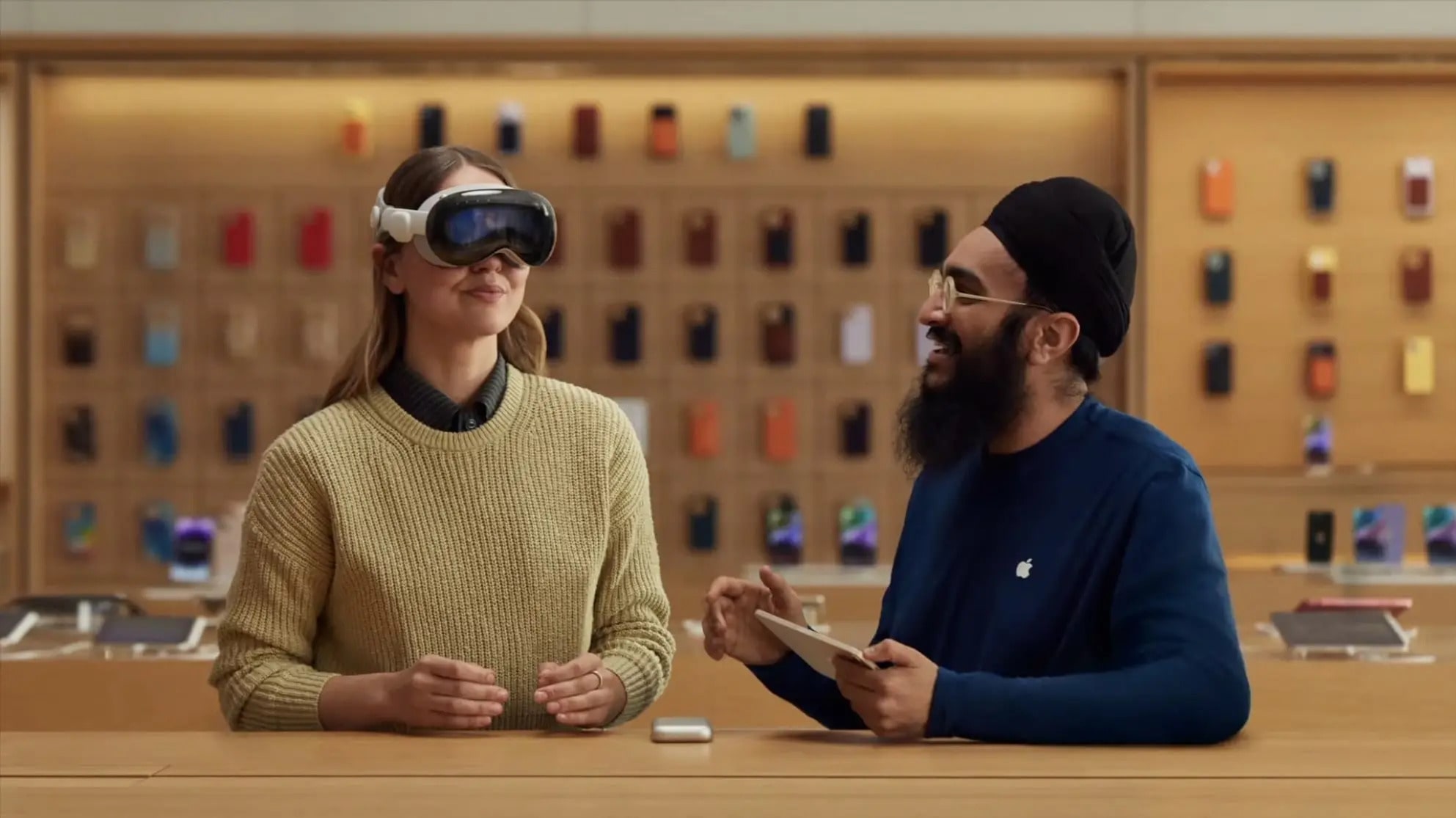 Apple Store staff shows customers how to use the Vision Pro headset.