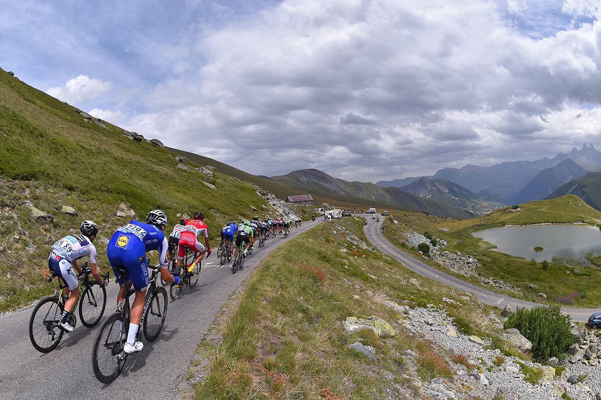 The Tour de France peloton snakes through the Alps