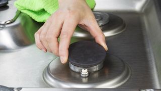 Removing a burner from gas stove top