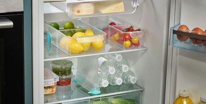 an organized fridge with storage drawers and dividers