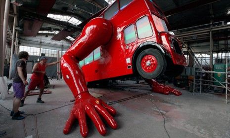 Workers for the Czech artist David Cerny check the hydraulic arms of his newest sculpture, &amp;quot;London Boosted&amp;quot; which will be displayed outside of the Czech Team&amp;#039;s Olympic headquarters in London.