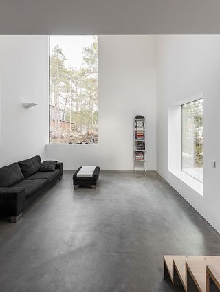 Living area with double volume height and grey polished floor