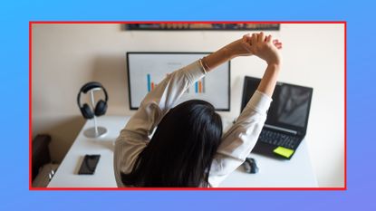 Woman stretching while working on computer from a home office, standing desk exercises