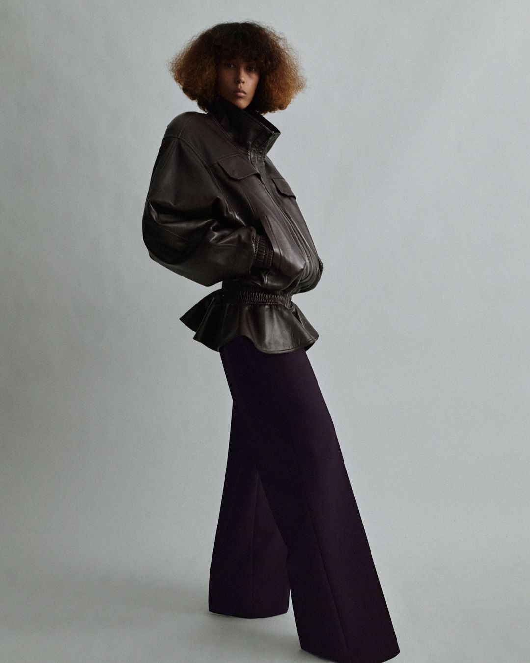 a woman wearing a leather funnel-neck jacket from Phoebe Philo's A2 collection