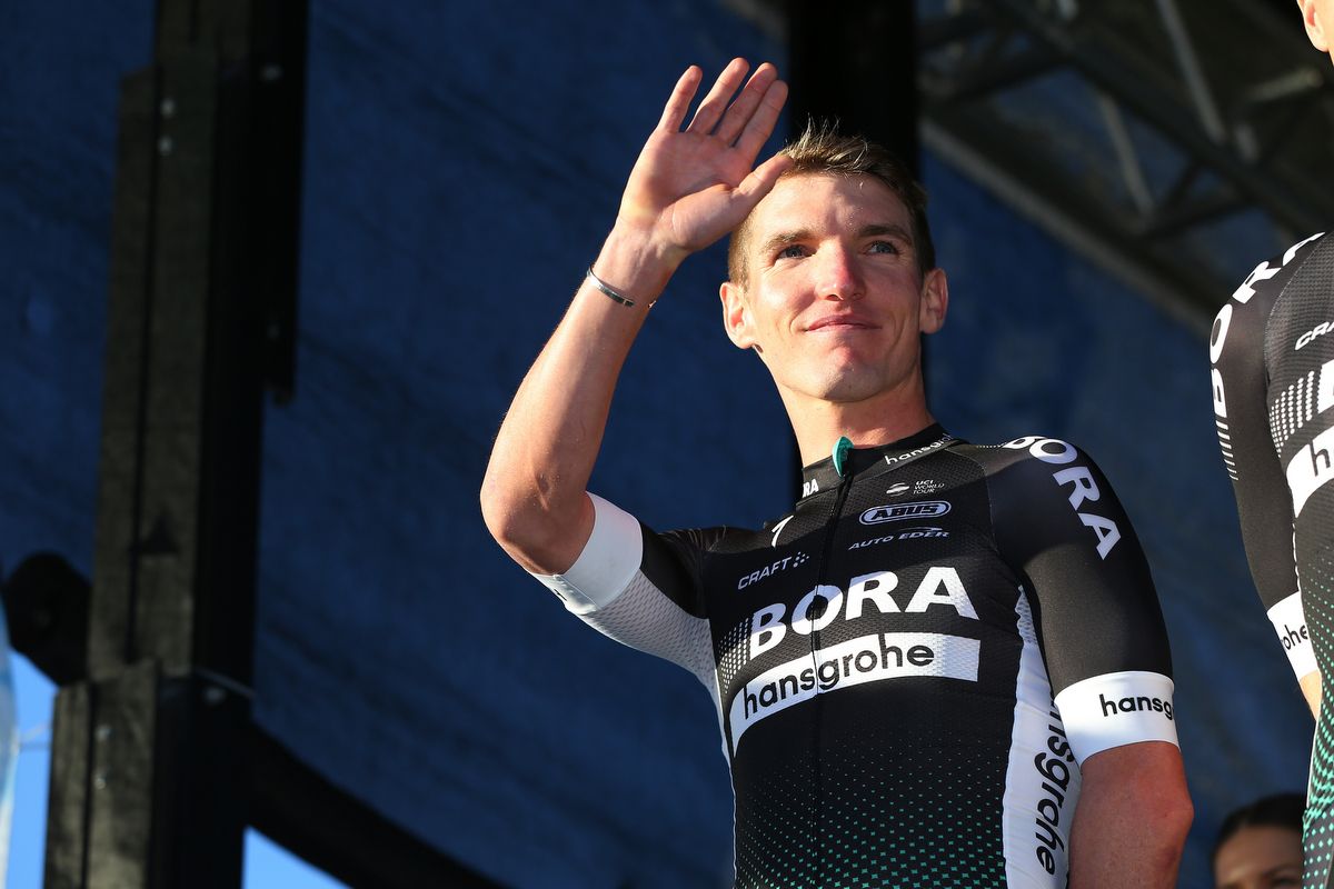 Jay McCarthy waves from the podium