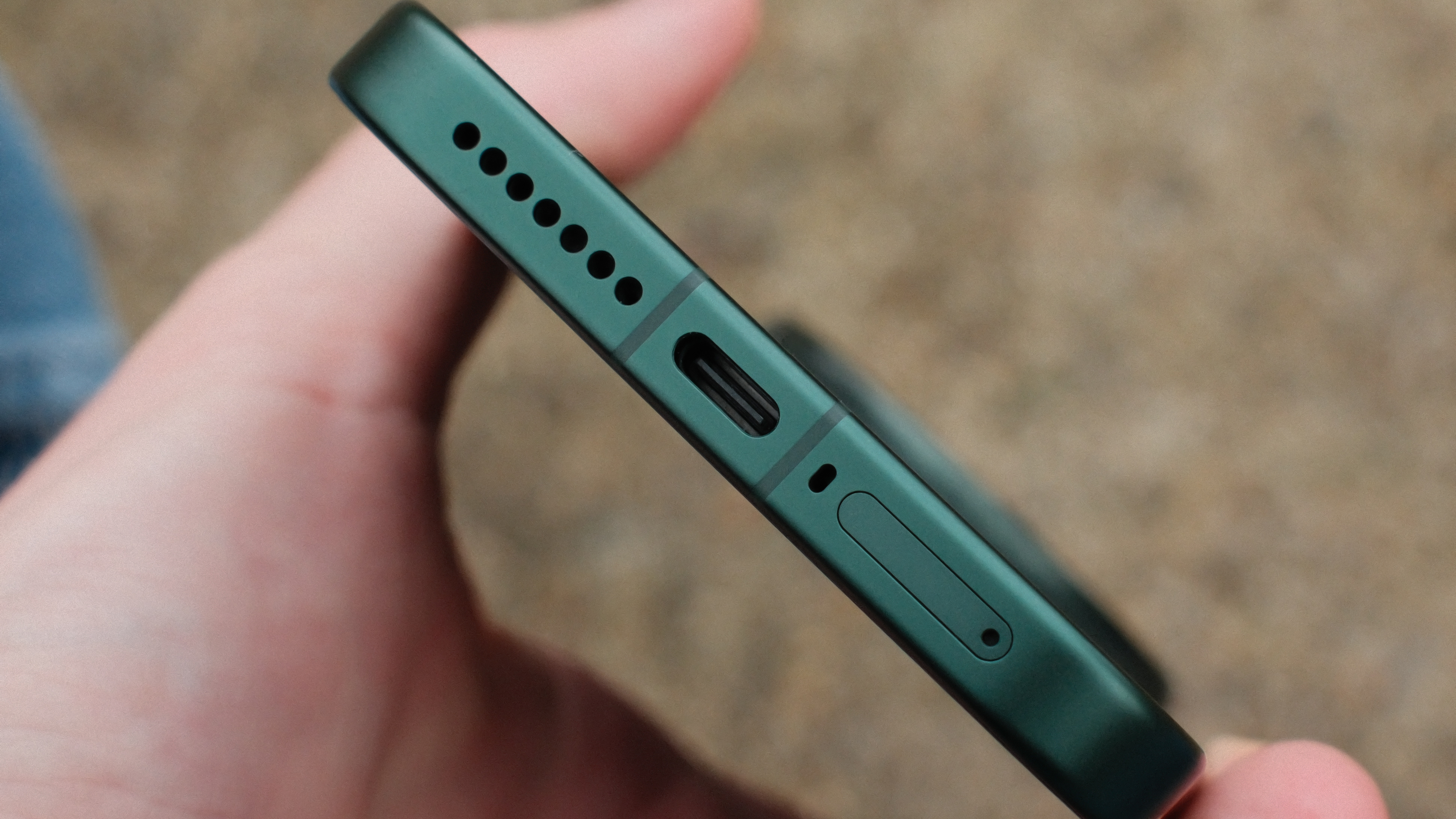 Bottom edge of the Xiaomi 17 Ultra showing USB-C port, speaker grille, microphone hole, and SIM tray.