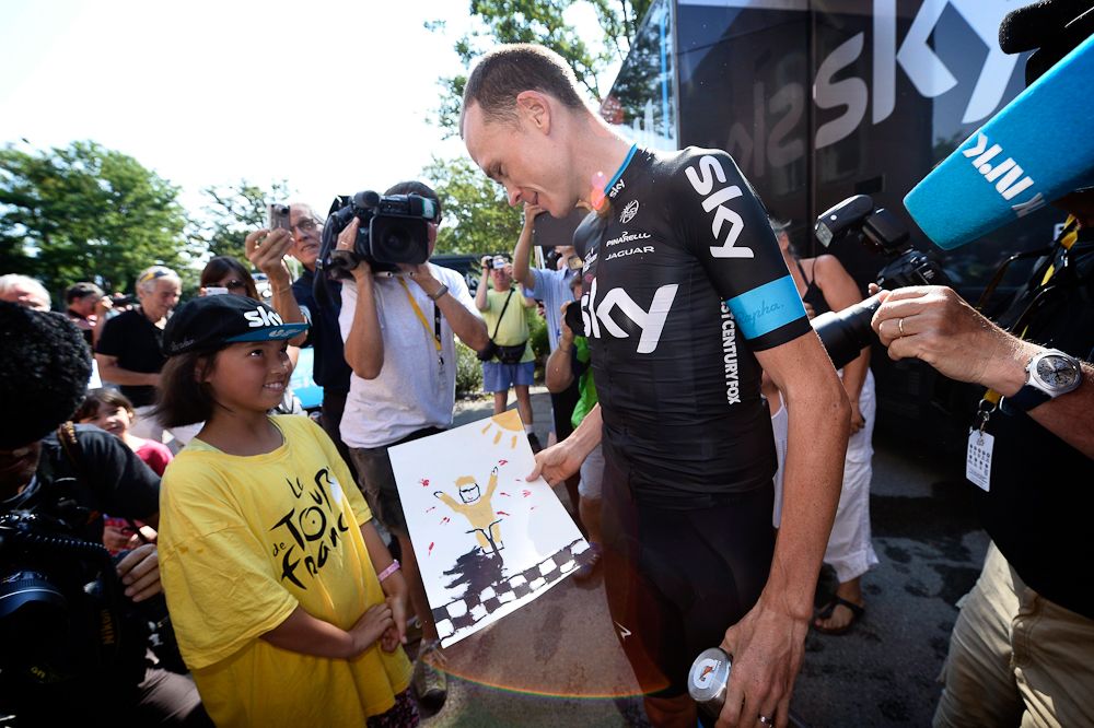 Chris Froome interacts with fans at the Team Sky bus.