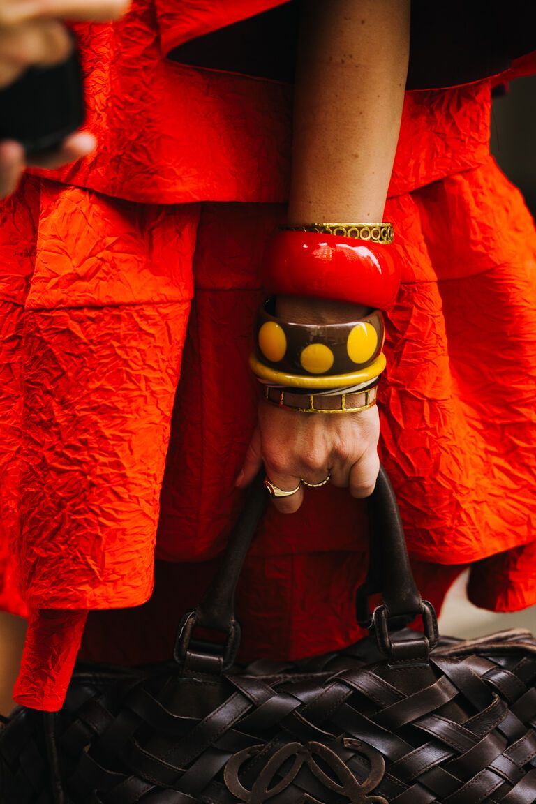 women at fashion week wearing the summer jewelry trend 2026 of stacks of bangles on their wrists