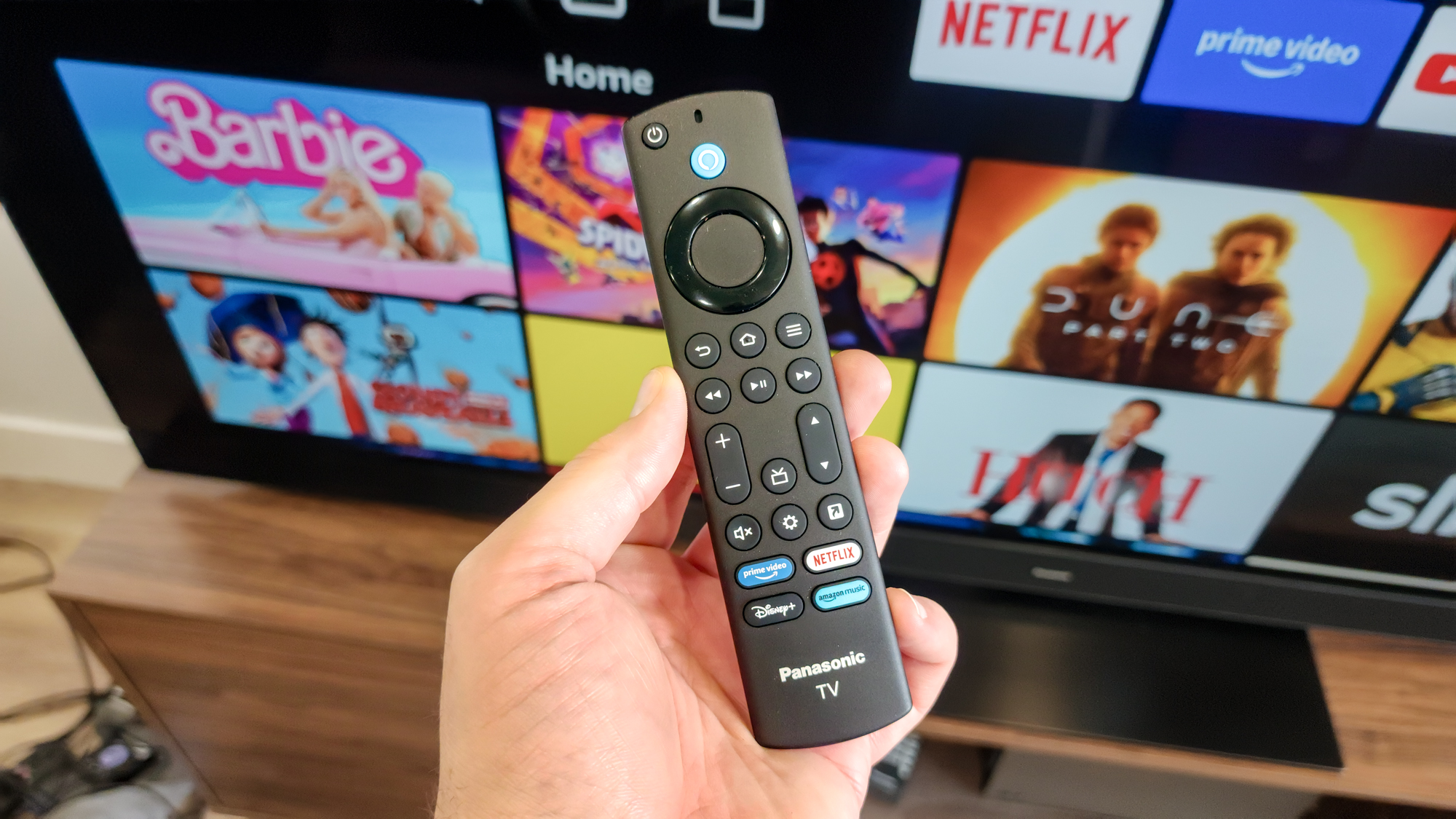 The Panasonic Z8BA remote in the hand on a Tom&#039;s Guide reviewer.