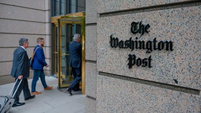 People walk into the headquarters of The Washington Post in Washington, D.C. 