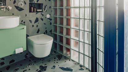 a small bathroom with glass bricks