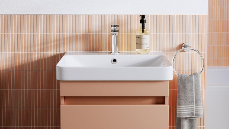 peach bathroom with peach tiles and matching vanity unit 