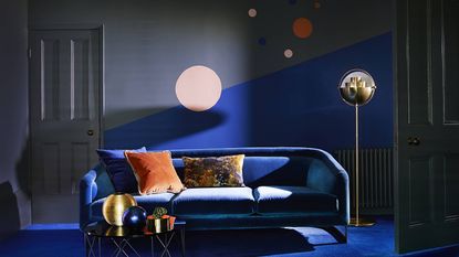 A dark grey and blue feature wall with painted circle shapes with blue carpet floor decor in living room