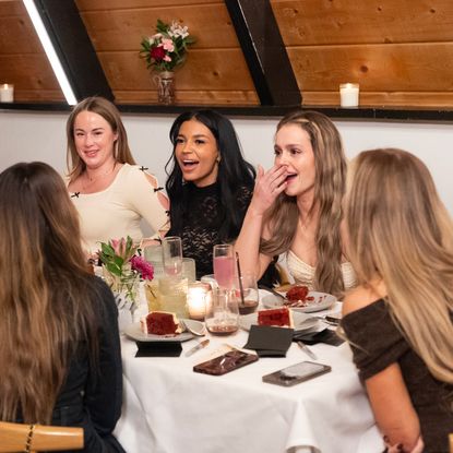 A table of women chatting over dinner, in 'The Secret Lives of Mormon Wives' season 2.