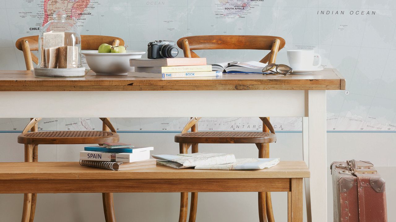 Table with chairs infront of map mural