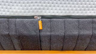 Branding on the orange zipper tab of the Emma Luxe mattress