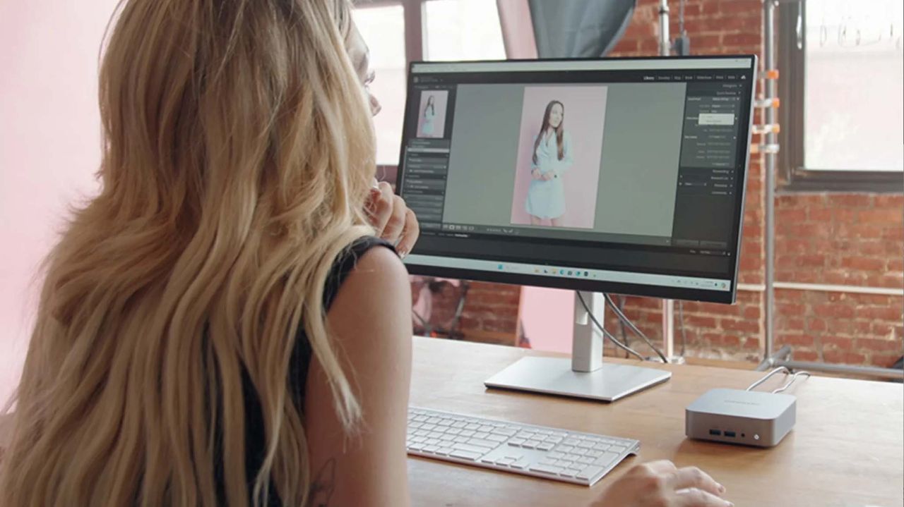 A woman working on a Geekom A8 mini PC in photo editing software.